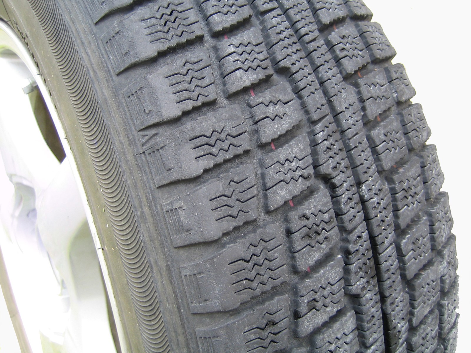 Close view of the tread on a studless winter tyre