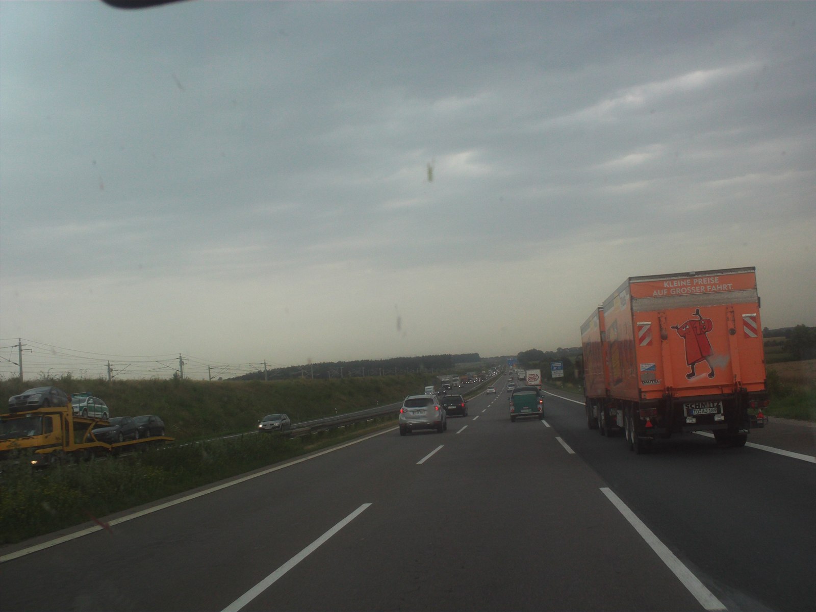 Traffic on the A9 motorway beneath cloudy skies