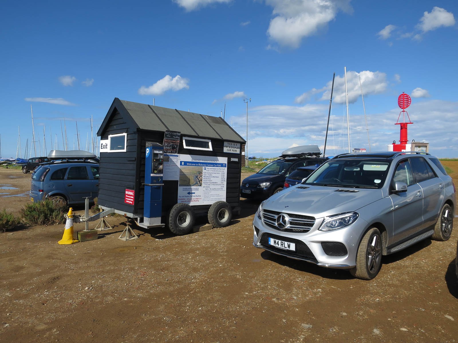 A small parked service trailer beside a vehicle