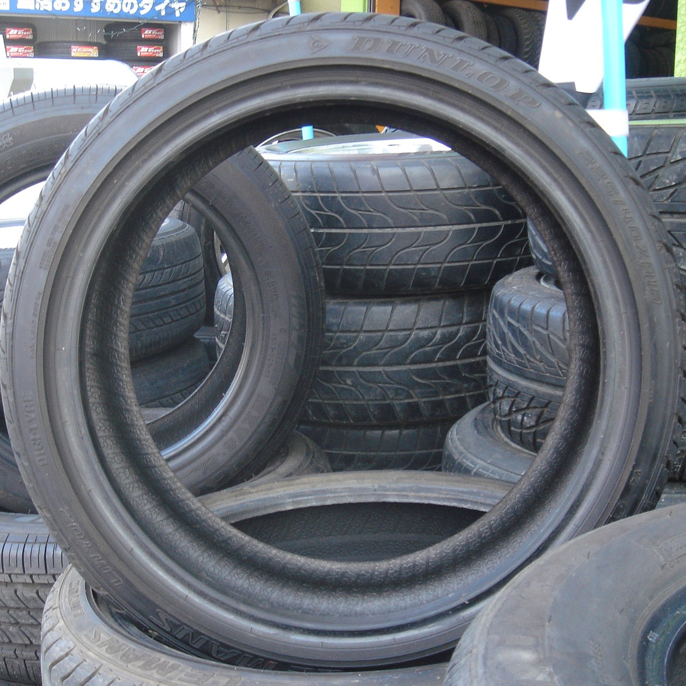 Several unmounted car tyres on display
