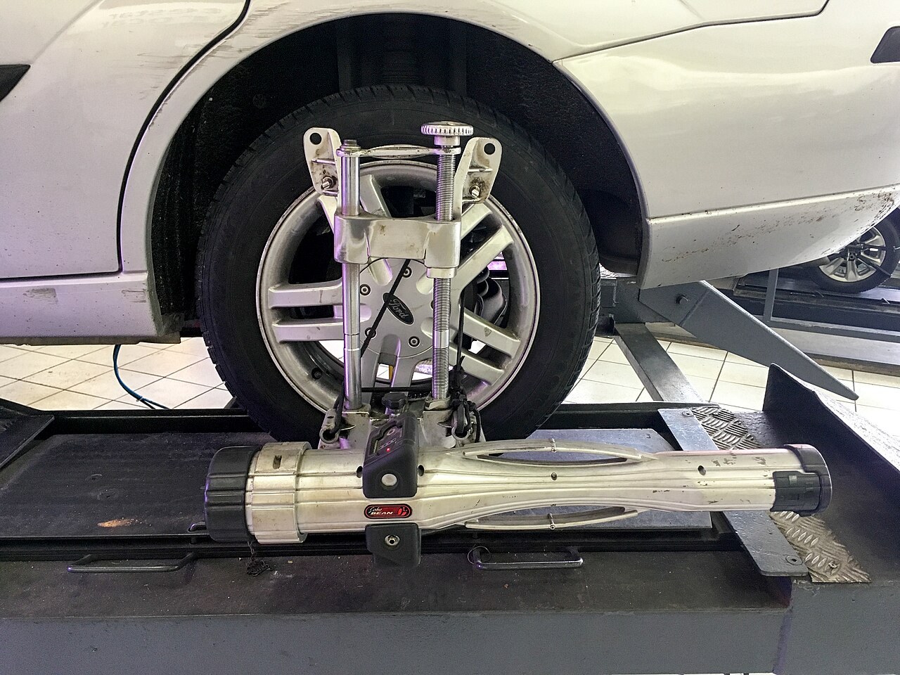Wheel alignment on a passenger car in a workshop