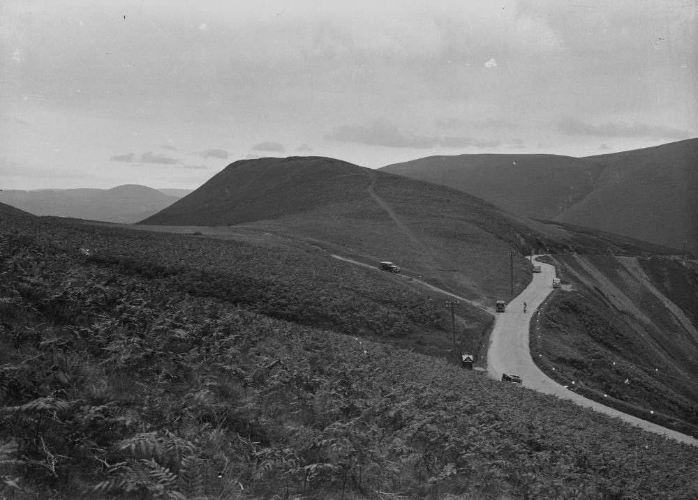 Historical photograph of a road through hilly terrain